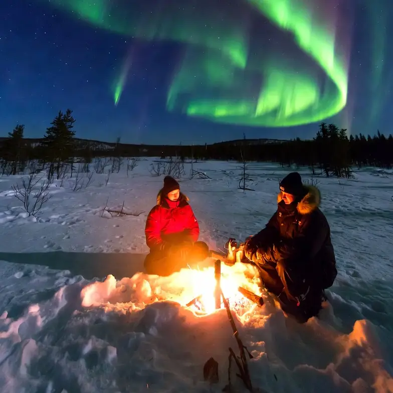 Snow mobile guides Northern lights